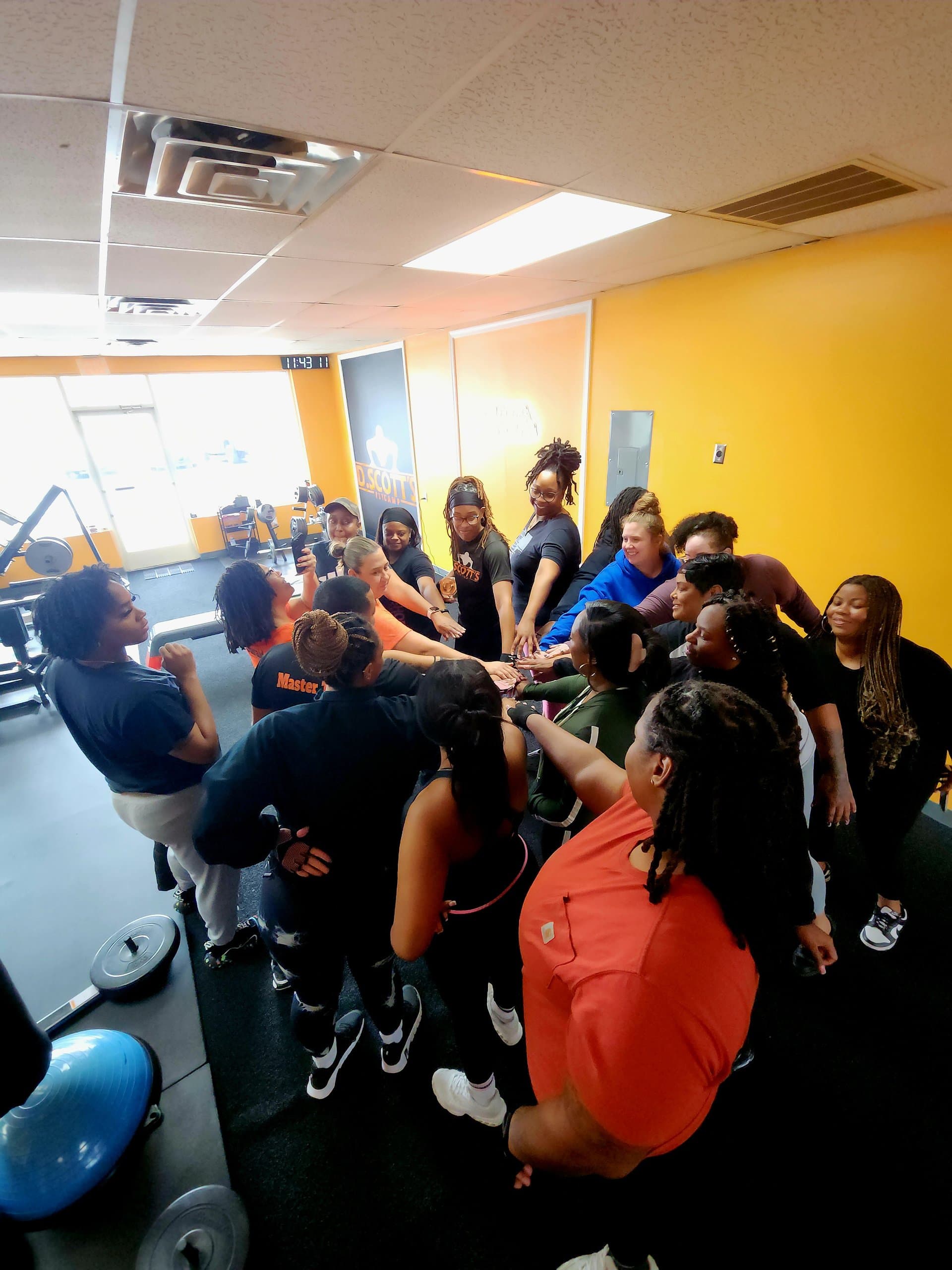 A team huddle at the end of a class at DScottsFitCamp in Newport News
